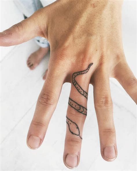 wrap around snake finger tattoo